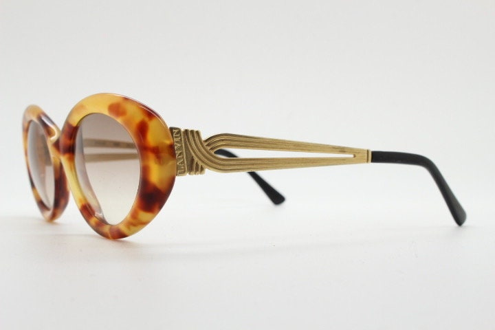 Lanvin 90s vintage chunky oval sunglasses made in France. Mottled honey brown acetate 60s design with detailed arms and light tone lenses