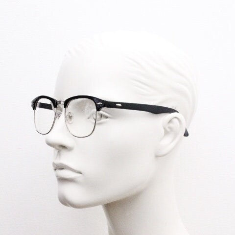 90s vintage black half frame eye glasses. Black gloss browline with silver wire rim frame and clear lenses. Classic 50s, 60s design. NOS