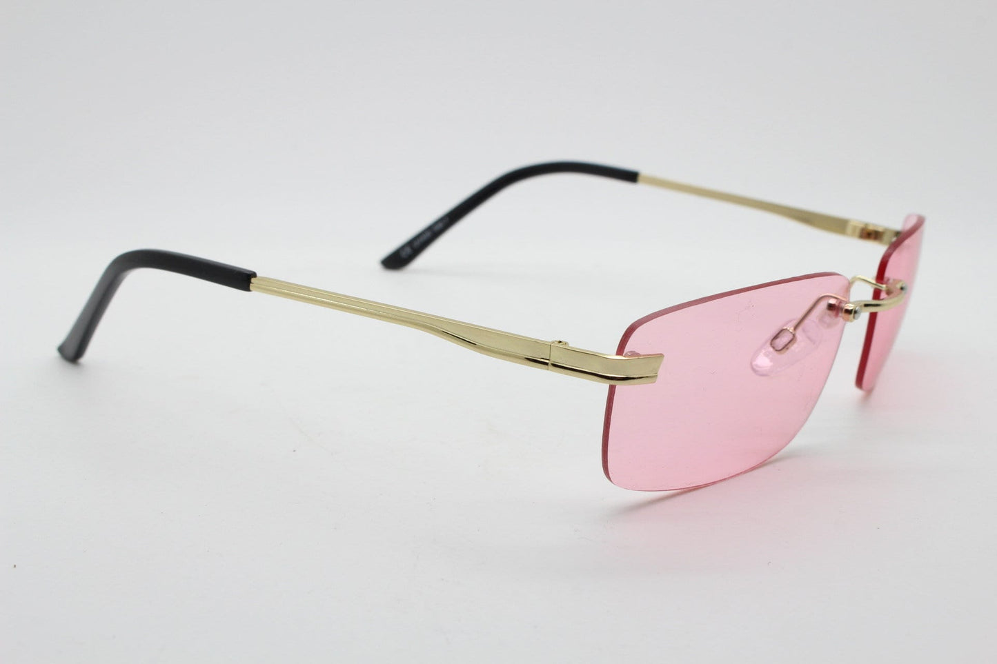 Y2K vintage frameless pink sunglasses. Rectangular lenses with gold bridge and arms. 2000s club kids. 00's. 90s Rave
