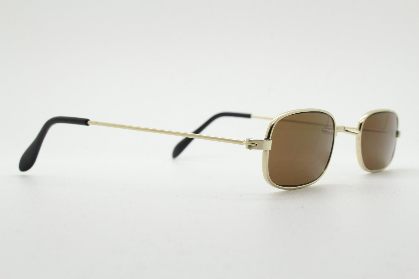80s vintage rectangular low profile metal sunglasses. Minimal 60s mens mod design in gold chrome frame with brown lenses. NOS