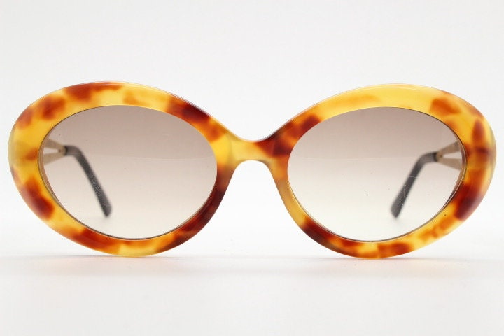 Lanvin 90s vintage chunky oval sunglasses made in France. Mottled honey brown acetate 60s design with detailed arms and light tone lenses
