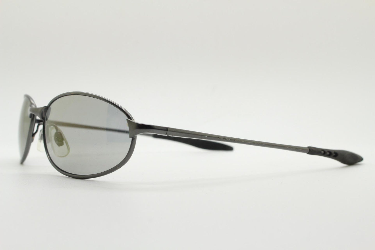90s vintage oval small bug eye sunglasses. Satin finish frame in gunmetal with straight spear arms. Y2K. 2000s. Unworn NOS