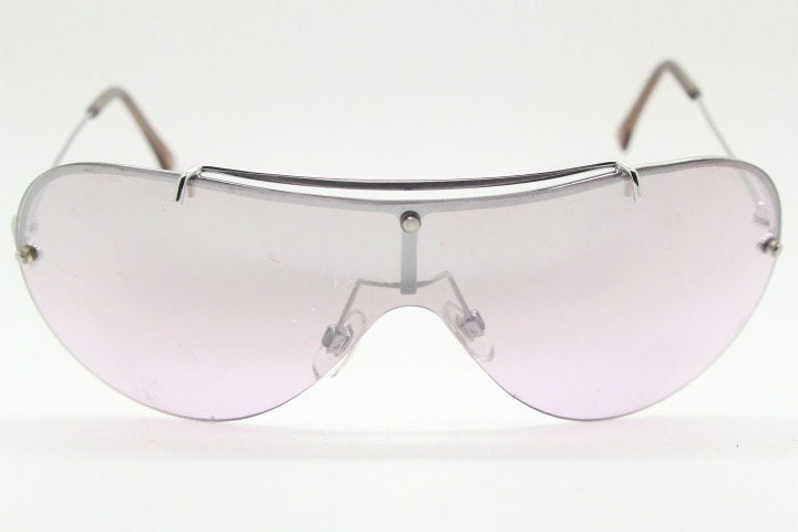Y2K vintage visor shield sunglasses. Silver chrome half frame with pink wraparound mono lens and mirror glaze. Mini mask. 00's. 2000's NOS