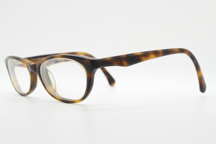 Calvin Klein Jeans modified cat eye glasses model CKJ918. Tortoise gloss low profile acetate optical frames. Prescription eyeglasses. RX
