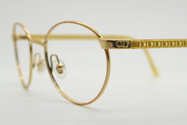 Christian Dior 90s vintage oval eye glasses made in Austria. Lustrous gold finish optical frame with CD chain link arms. Prescription RX NOS