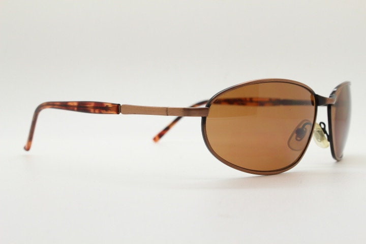 Y2K vintage small bug eye aviator sunglasses. Curved copper brushed finish solid metal frame with tortoise arms. Unused 2000s NOS