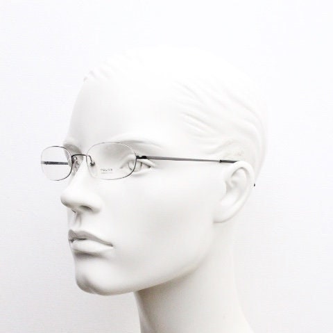 Police 90s vintage oval half rim eye glasses made in Italy. Minimal lightweight optical frame in gunmetal grey. Prescription RX Spectacles