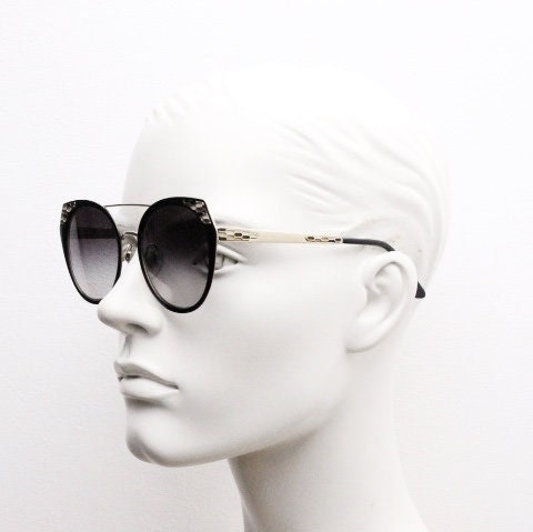 Bulgari round cropped cat eye sunglasses made in Italy. Womens black and gold frame with honeycomb patterns and smoky graduating lenses