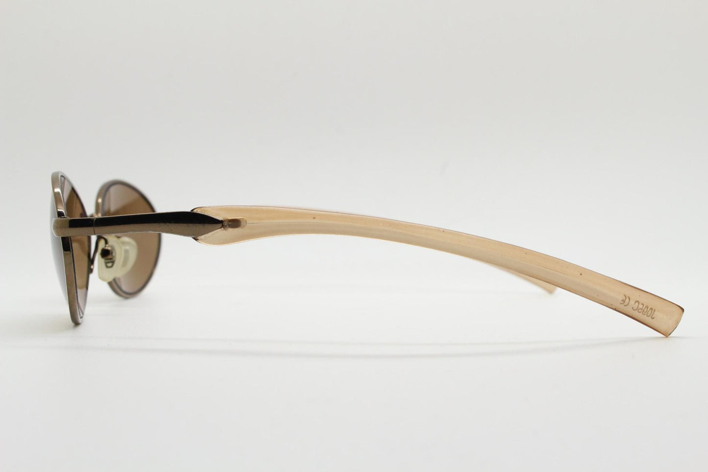 90s vintage small oval bug eye sunglasses. Minimal brown chrome finish metal frame with transparent curved arms. Y2K. Unused NOS