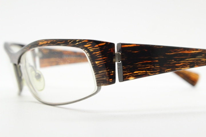 Alain Mikli 90s vintage eye glasses hand made in France. Low profile wrap around half frame in 'wood grain' acetate. Optical prescription RX