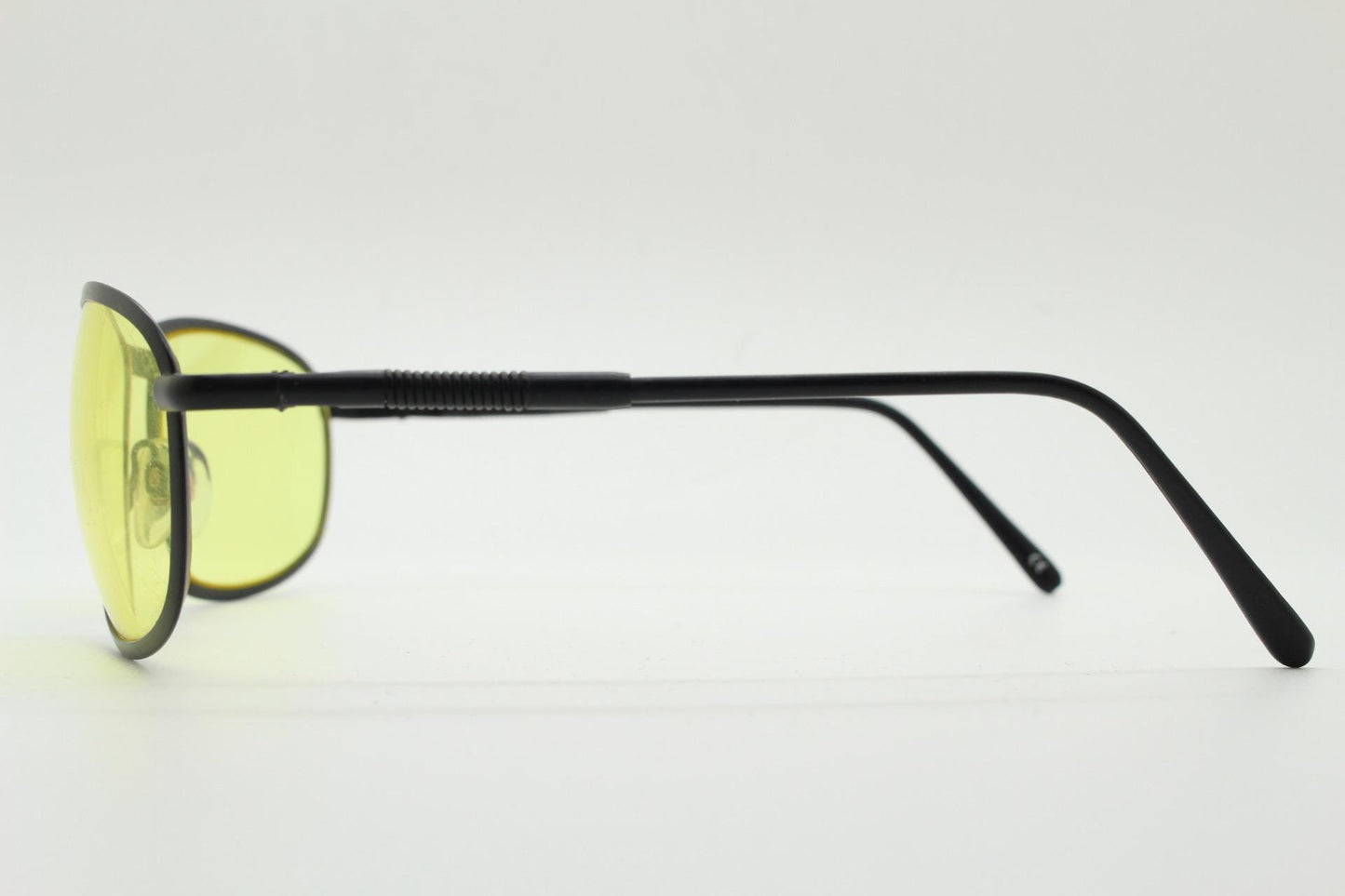 90s vintage oval bug eye sunglasses. Matt black metal frame with blazing yellow lenses and ingenious temple springs. 2000s. NOS