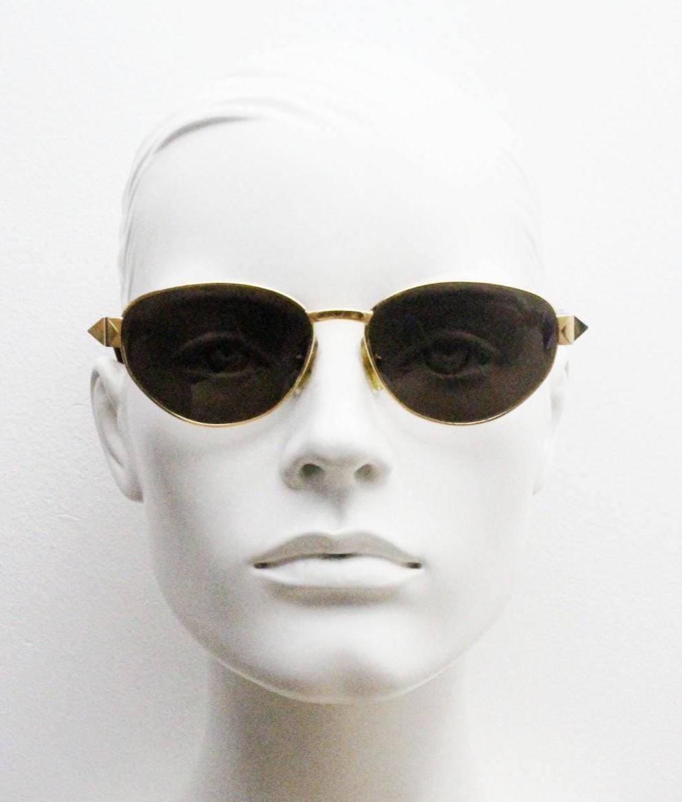 Gianfranco Ferre oval sunglasses made in Italy. Gold frame with triangular tortoise acetate arms and green lenses. 90s vintage GFF