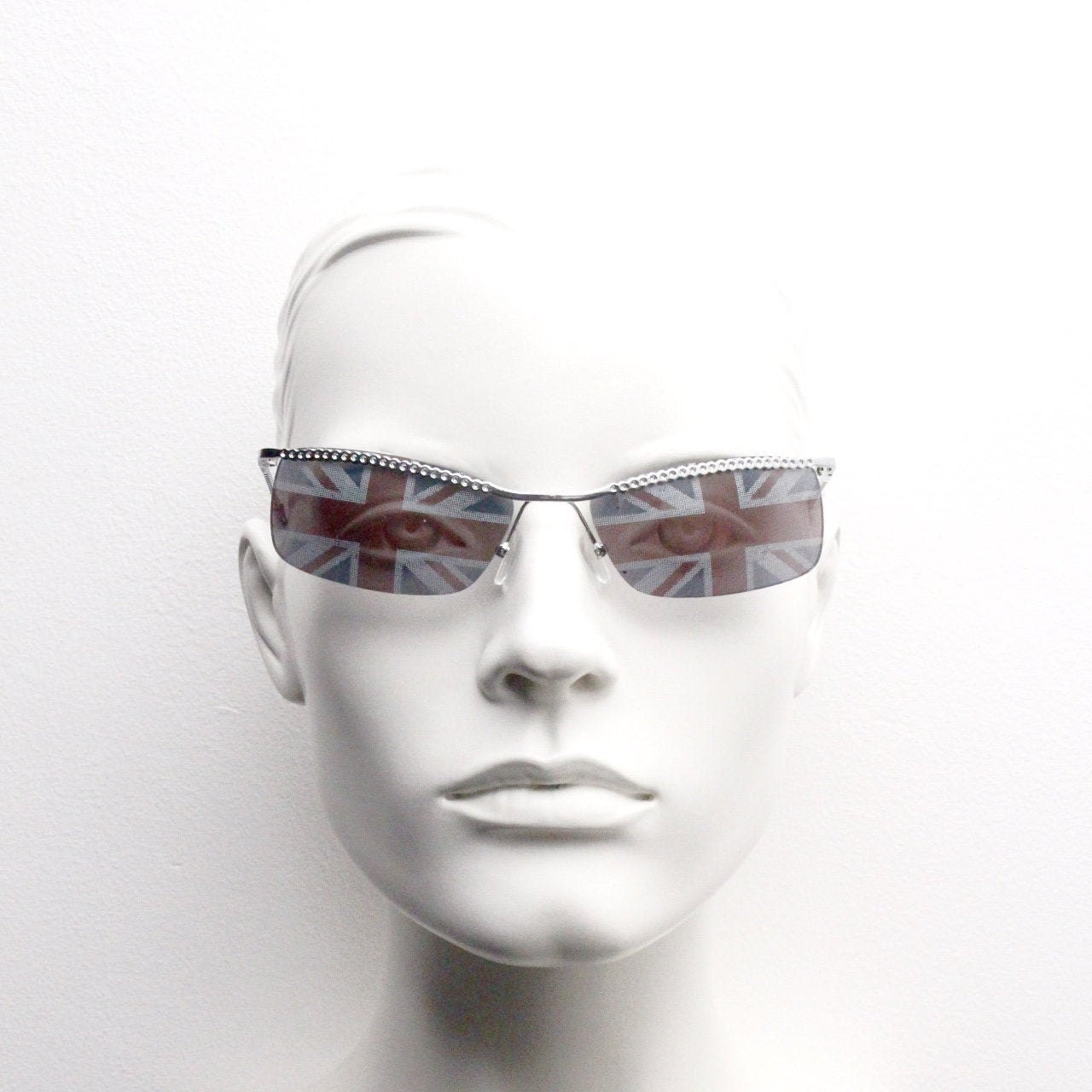 90s vintage half frame Union Jack sunglasses. Curved lens suspended on a sparkling chrome brow. Unused NOS. Brit pop girl power
