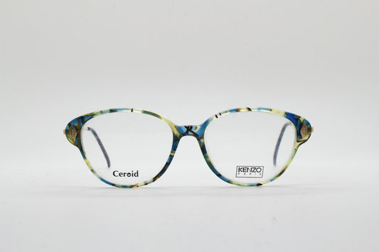 Kenzo 90s vintage cat eye glasses hand made in France. Transparent patterned optical frame with ornate arm details. Womens Prescription. NOS