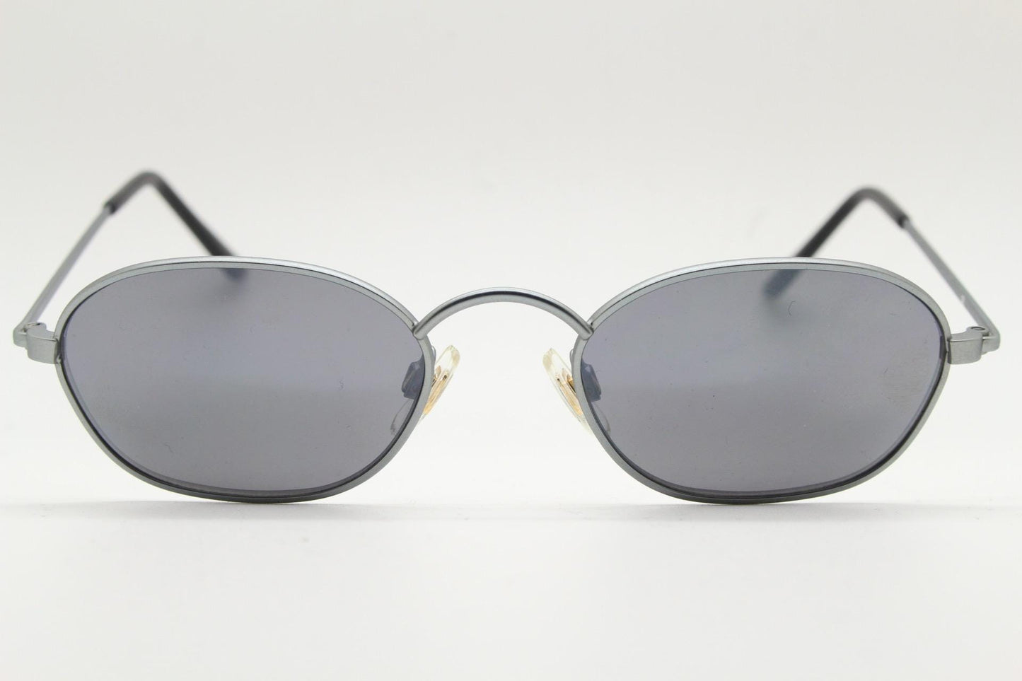 90s vintage small angular oval bug eye sunglasses. Minimal brushed satin finish frame with silver mirror lenses. Y2K. 2000s. Unworn NOS