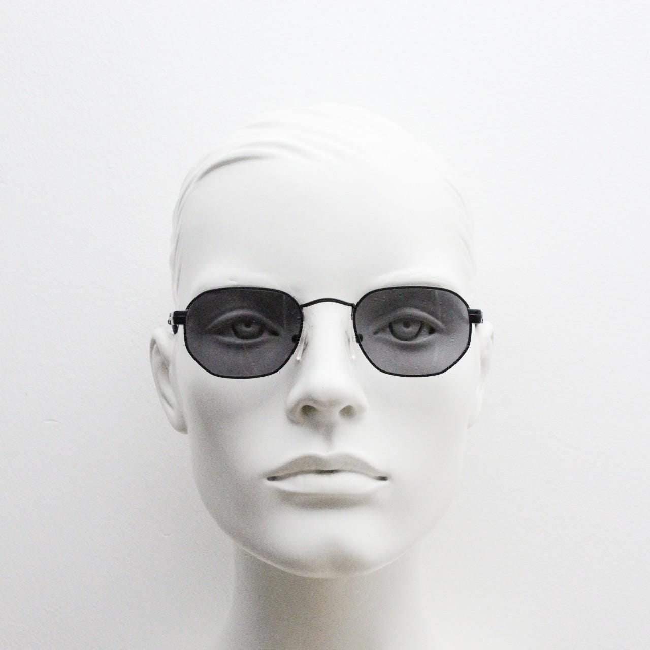 Prestige 90s vintage small oval sunglasses model 119 made in Italy. Black matt metal frame with with subtle angular facets, NOS octagon