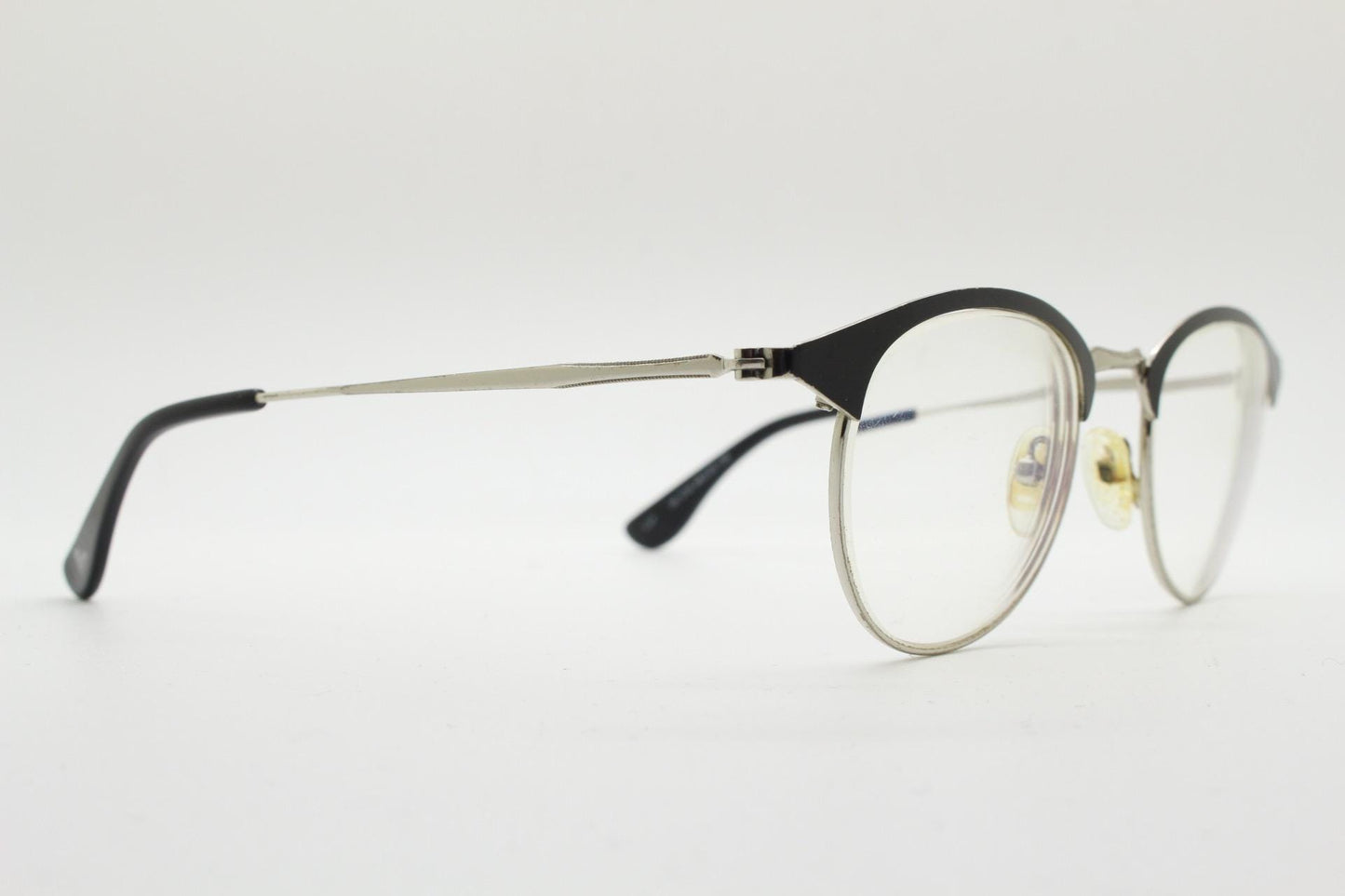 Lupo and Co round eye glasses with pointed corners. Flat metal silver optical frames with black browline. Prescription eyeglasses. RX
