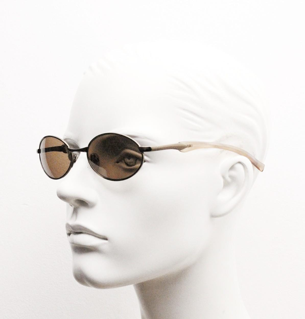 90s vintage small oval bug eye sunglasses. Minimal brown chrome finish metal frame with transparent curved arms. Y2K. Unused NOS