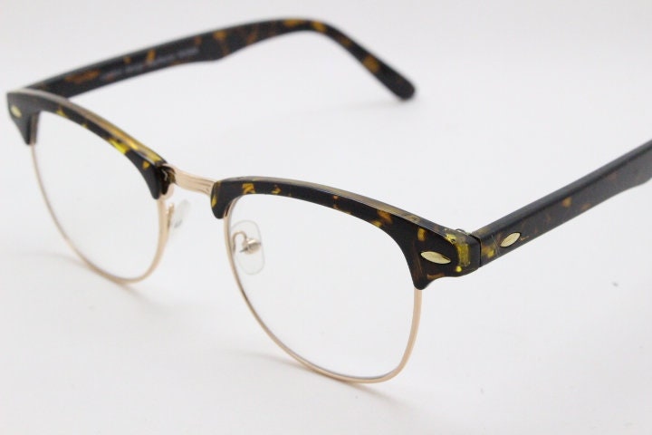 90s vintage half frame glasses. Tortoise browline eyeglasses in a gloss finish with gold underwire and clear lenses . Mens 50s, 60s design