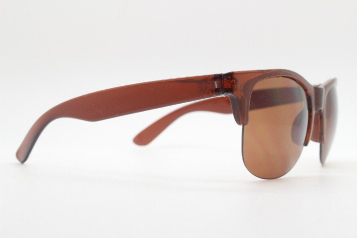 90s vintage modified wayfarer design sunglasses. Transparent brown browline half frame with brown or green interchangeable lenses . NOS