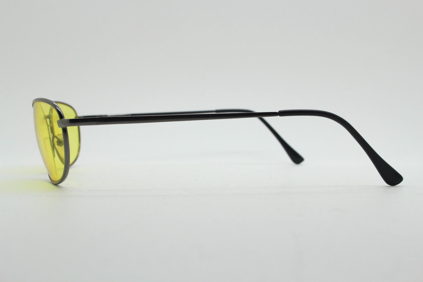 Y2K vintage small oval bug eye sunglasses. Gunmetal grey satin finish frame with blazing canary yellow lenses. Unused 2000s NOS. 90s micro