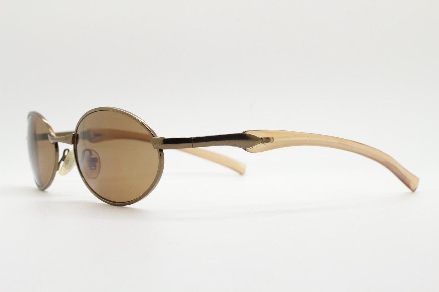 90s vintage small oval bug eye sunglasses. Minimal brown chrome finish metal frame with transparent curved arms. Y2K. Unused NOS