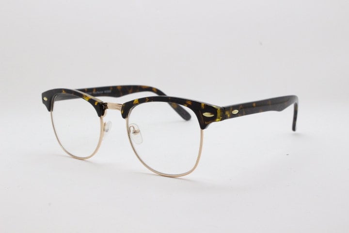 90s vintage half frame glasses. Tortoise browline eyeglasses in a gloss finish with gold underwire and clear lenses . Mens 50s, 60s design
