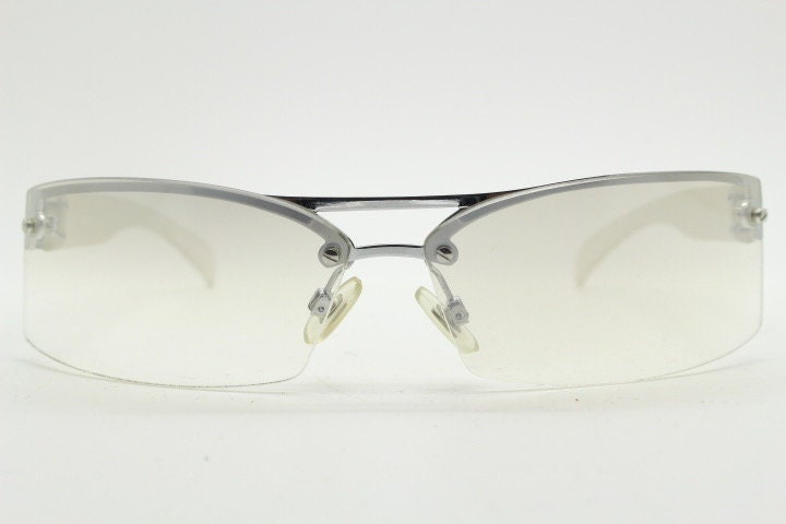 Y2K vintage wraparound sunglasses. Sick fashion grail half frame in silver chrome with extra light tone curving mirrored lenses. 2000's NOS