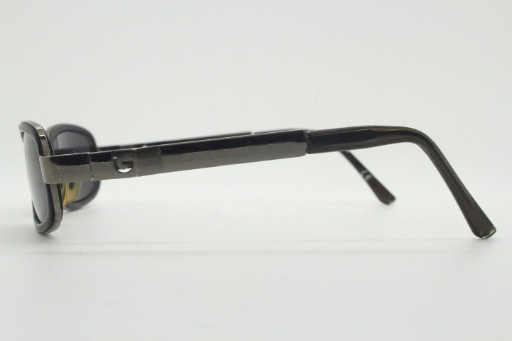 Byblos 90s vintage low profile rectangular sunglasses made in Italy. Gunmetal grey chrome frame with black insets and cut out arm logo's