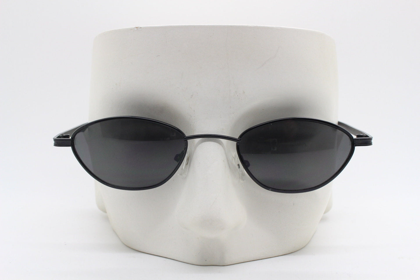 90s vintage low profile sunglasses. Minimal small black angular oval metal frame with matching lenses, Unused. BNWT