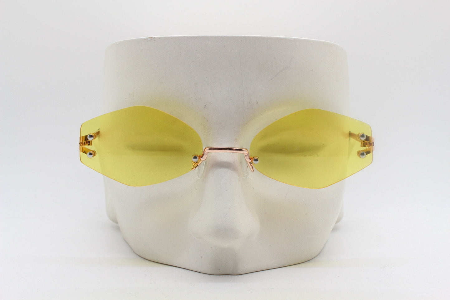 Y2K vintage frameless hexagon sunglasses. Bright yellow lenses with rose gold bridge and arms. 2000s, 00's. 90s