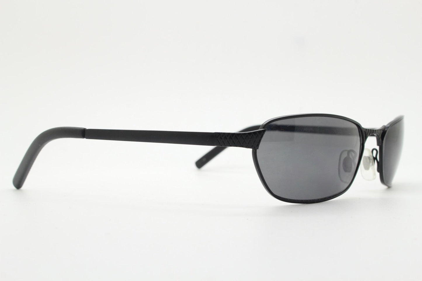 90s vintage wraparound sunglasses. Black satin finish on rectangular frame with unassuming style details. 2000's. Y2K. Unused NOS bug eye