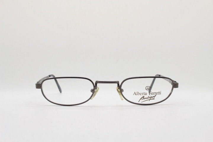 Alberta Ferretti 90s vintage oval eye glasses made in Italy. Small grey metal optical frame with ornate arm pattern. Prescription RX. NOS