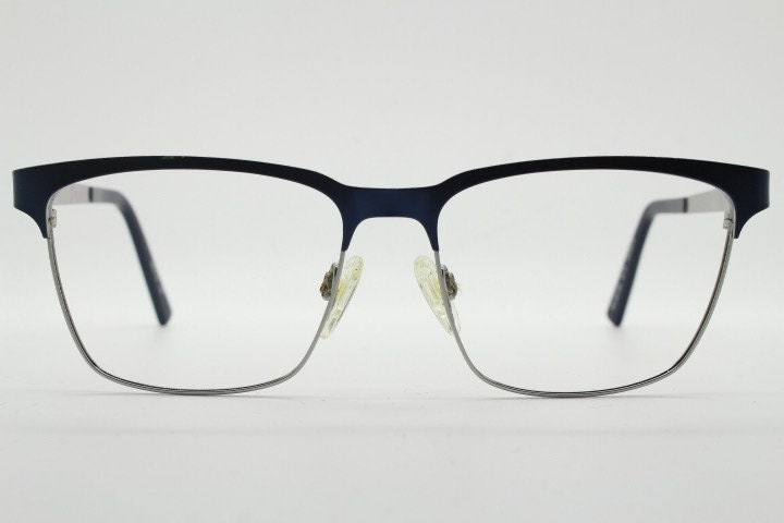 Karl Lagerfeld squared wayfarer shape eye glasses. Navy check pattern arms with satin finish brow optical frames. Prescription eyeglasses.