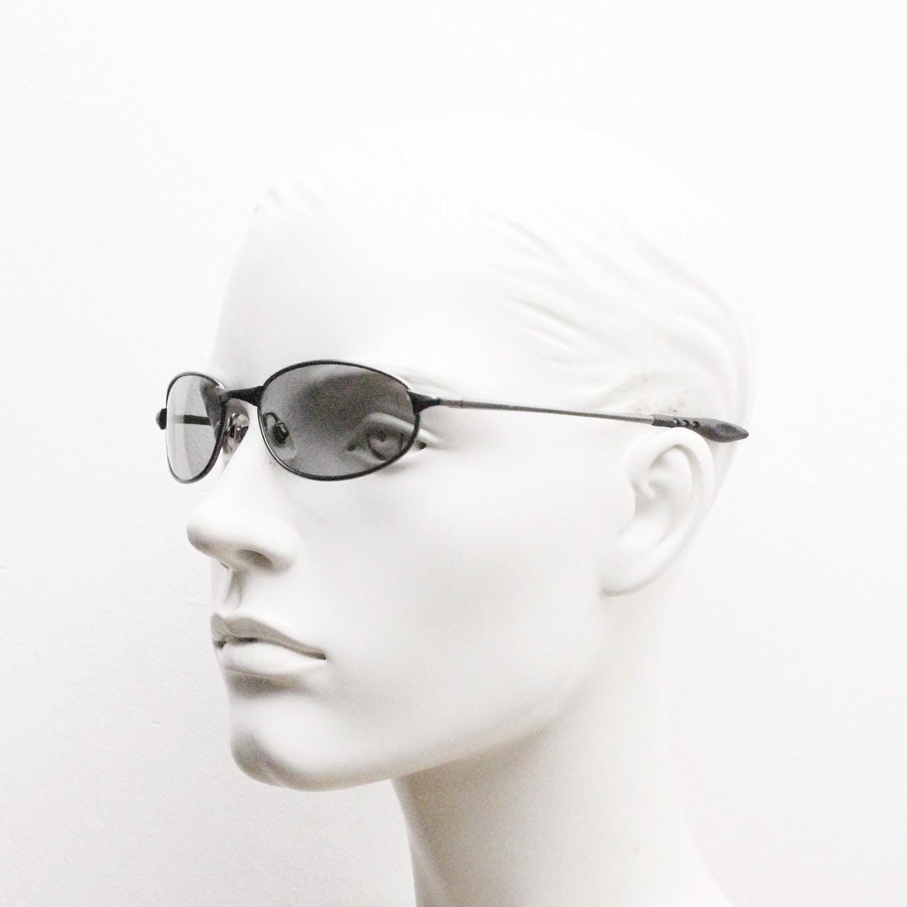 90s vintage oval small bug eye sunglasses. Satin finish frame in gunmetal with straight spear arms. Y2K. 2000s. Unworn NOS