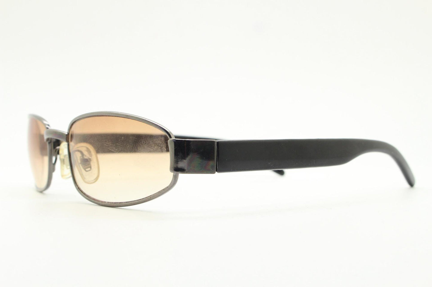 90s vintage oval sunglasses small bug eye with light tone lenses. Satin finish brown metal frame with black arms. 2000's. NOS