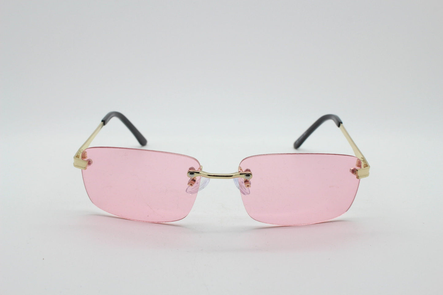 Y2K vintage frameless pink sunglasses. Rectangular lenses with gold bridge and arms. 2000s club kids. 00's. 90s Rave