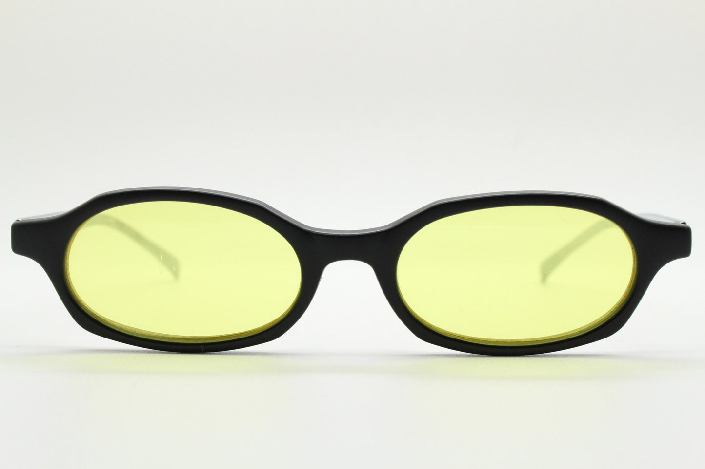 Vintage 90s oval sunglasses. Black low profile matt finish front with yellow lenses and silver chrome arms. Micro