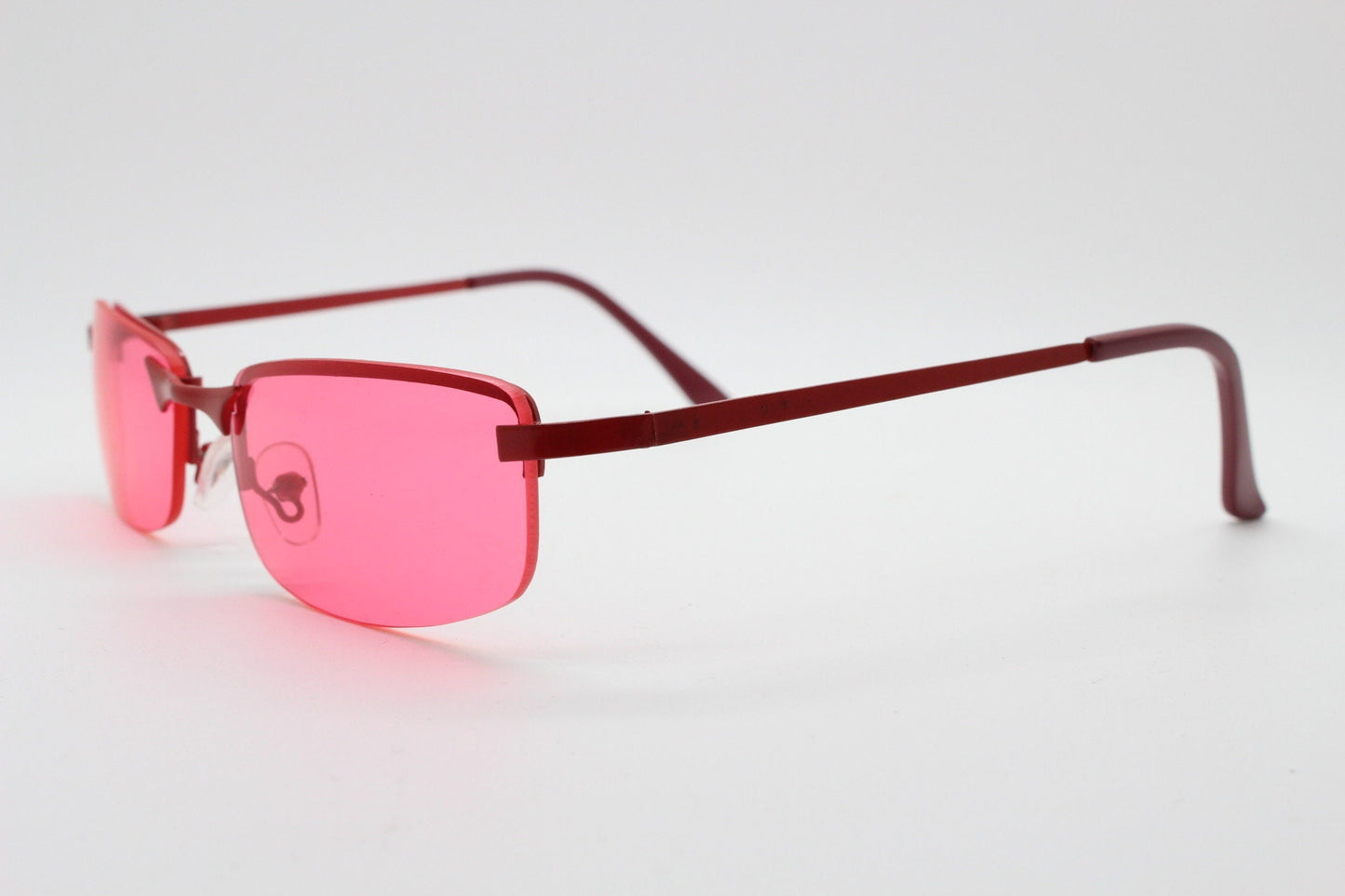 Y2K vintage half frame sunglasses with rectangular pink lenses and matching frame colours. 2000s NOS. 00's. 90s Rave