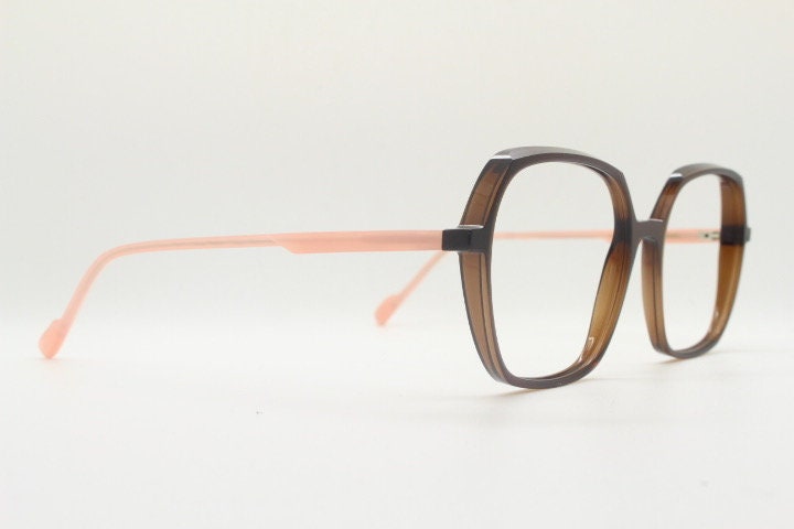 Caroline Abram square hexagon eye glasses model Caline. Dark brown acetate optical frame with pink arms. Prescription RX spectacles