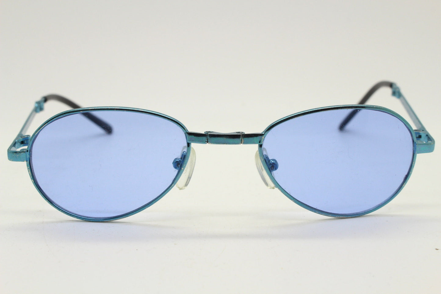Y2K micro foldable oval sunglasses. Sky lenses in a small folding matching coloured compact frame. Folder. Rave 2000s. 90s NOS