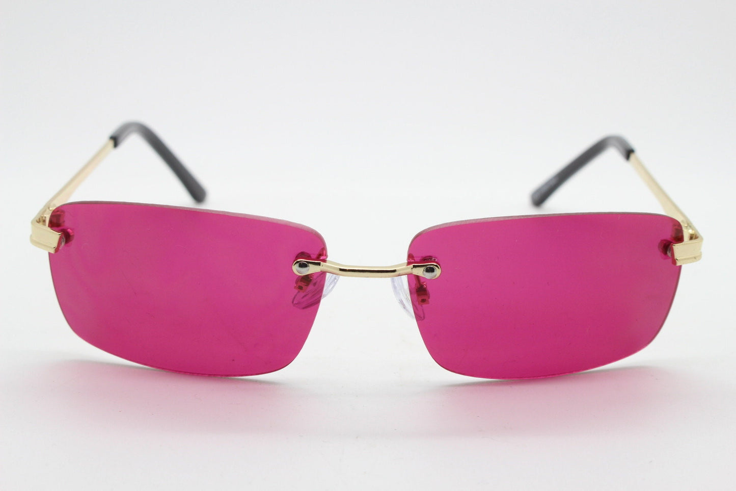 Y2K vintage frameless pink sunglasses. Rectangular lenses with gold bridge and arms. 2000s club kids. 00's. 90s Rave