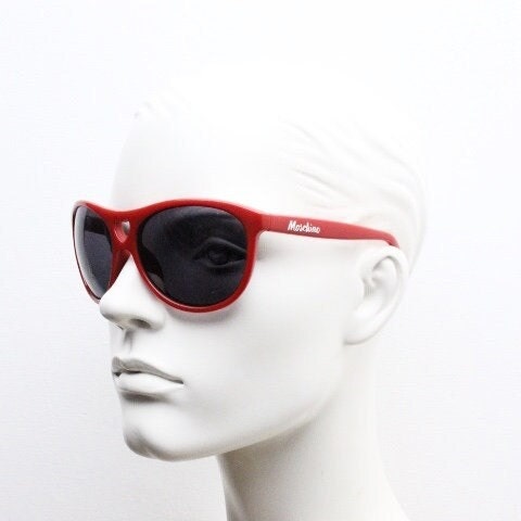 Moschino oversized Y2K vintage sunglasses. Characteristic crimson red acetate frame with cut out heart bridge. 2000s
