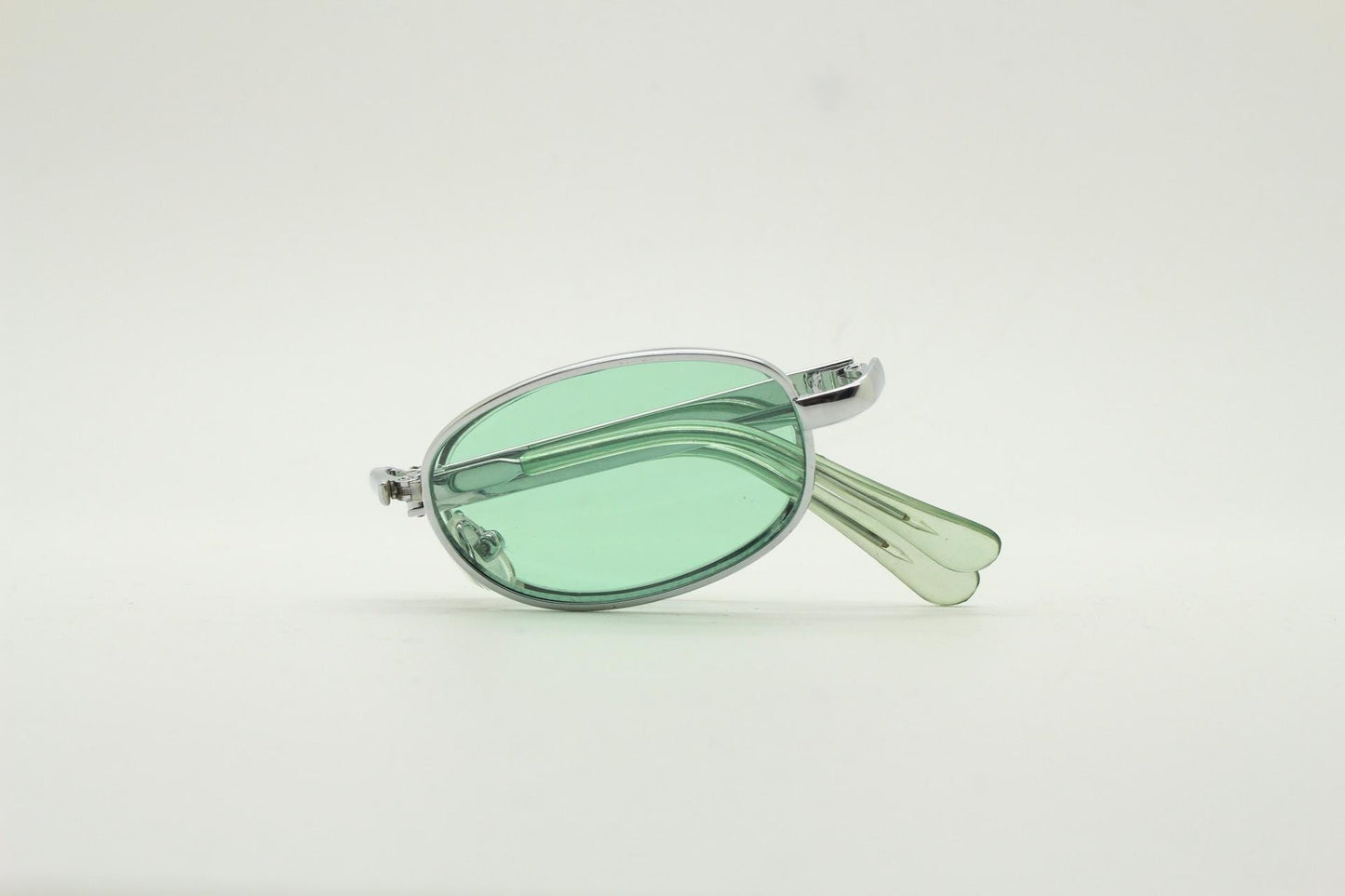 90s micro foldable oval sunglasses. Light green lenses in a small silver folding compact frame. Folder. Rave 2000s. Y2K. NOS