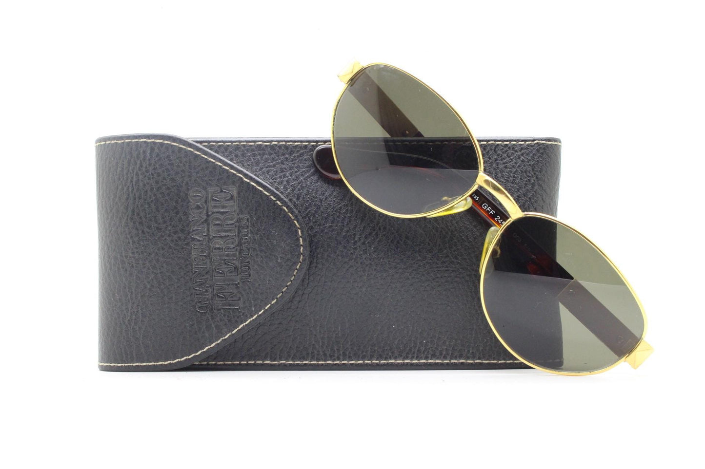 Gianfranco Ferre oval sunglasses made in Italy. Gold frame with triangular tortoise acetate arms and green lenses. 90s vintage GFF