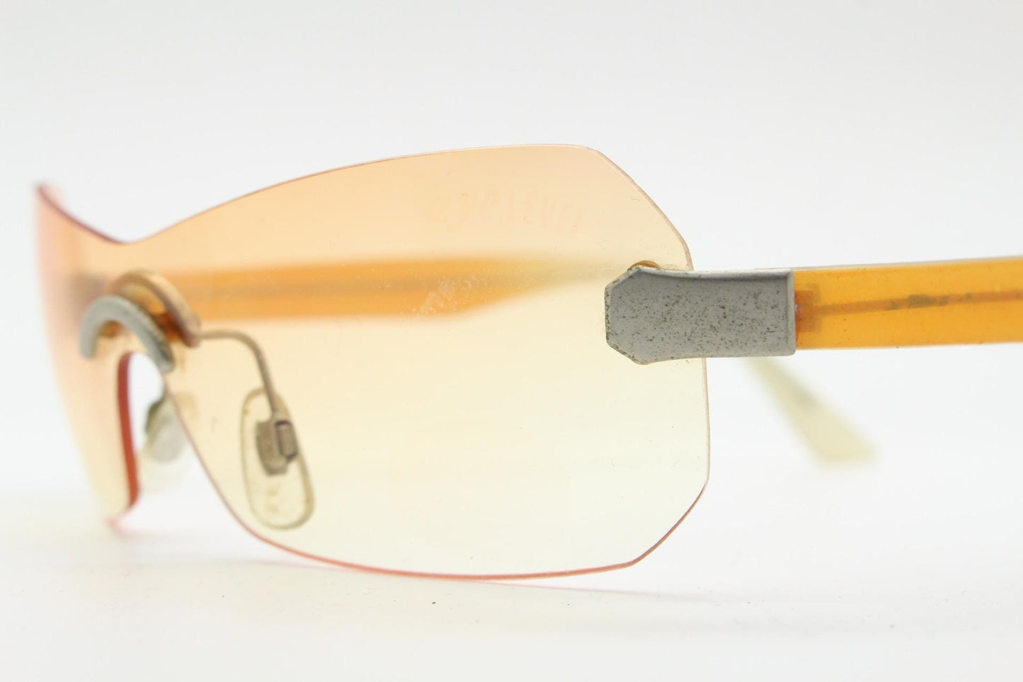 Y2K vintage frameless shield sunglasses. Dynamic 2000's light tone orange mono lens visor with matt silver trim. 00's Cosplay mini mask. NOS