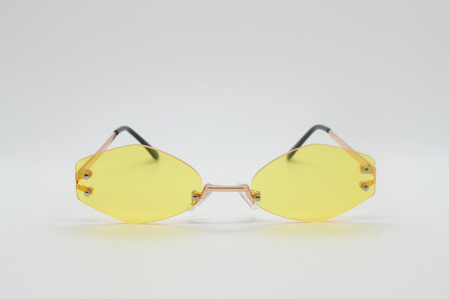 Y2K vintage frameless hexagon sunglasses. Bright yellow lenses with rose gold bridge and arms. 2000s, 00's. 90s