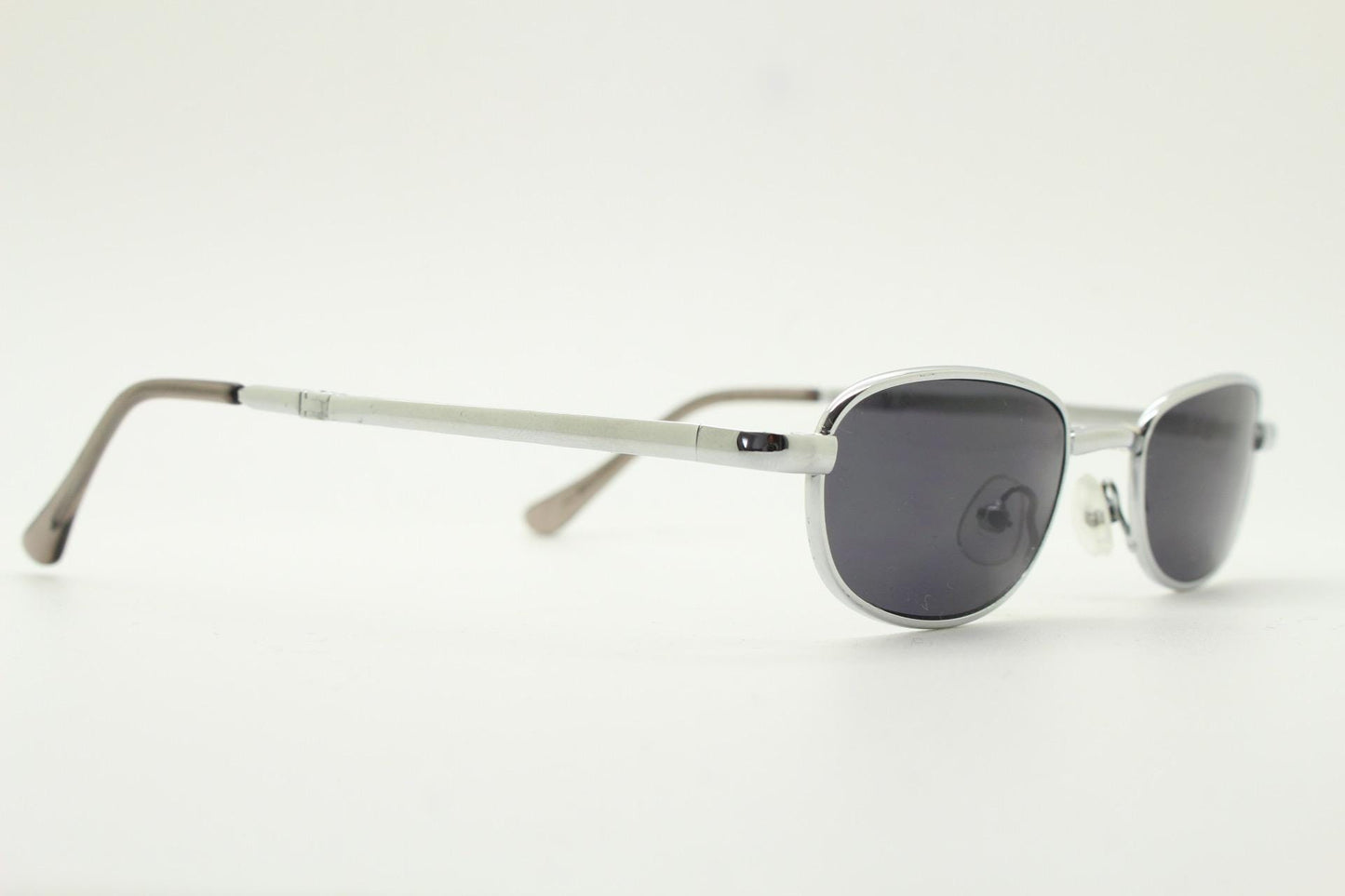 90s micro foldable rectangular sunglasses. Dark grey lenses in a small chrome folding compact frame. Folder. Rave 2000s. Y2K NOS