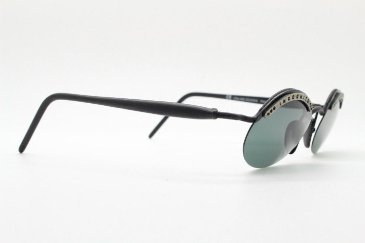 Inkognito 90s vintage small oval sunglasses. Matt finish half frame with spell out logo brow and polarising lenses. NOS