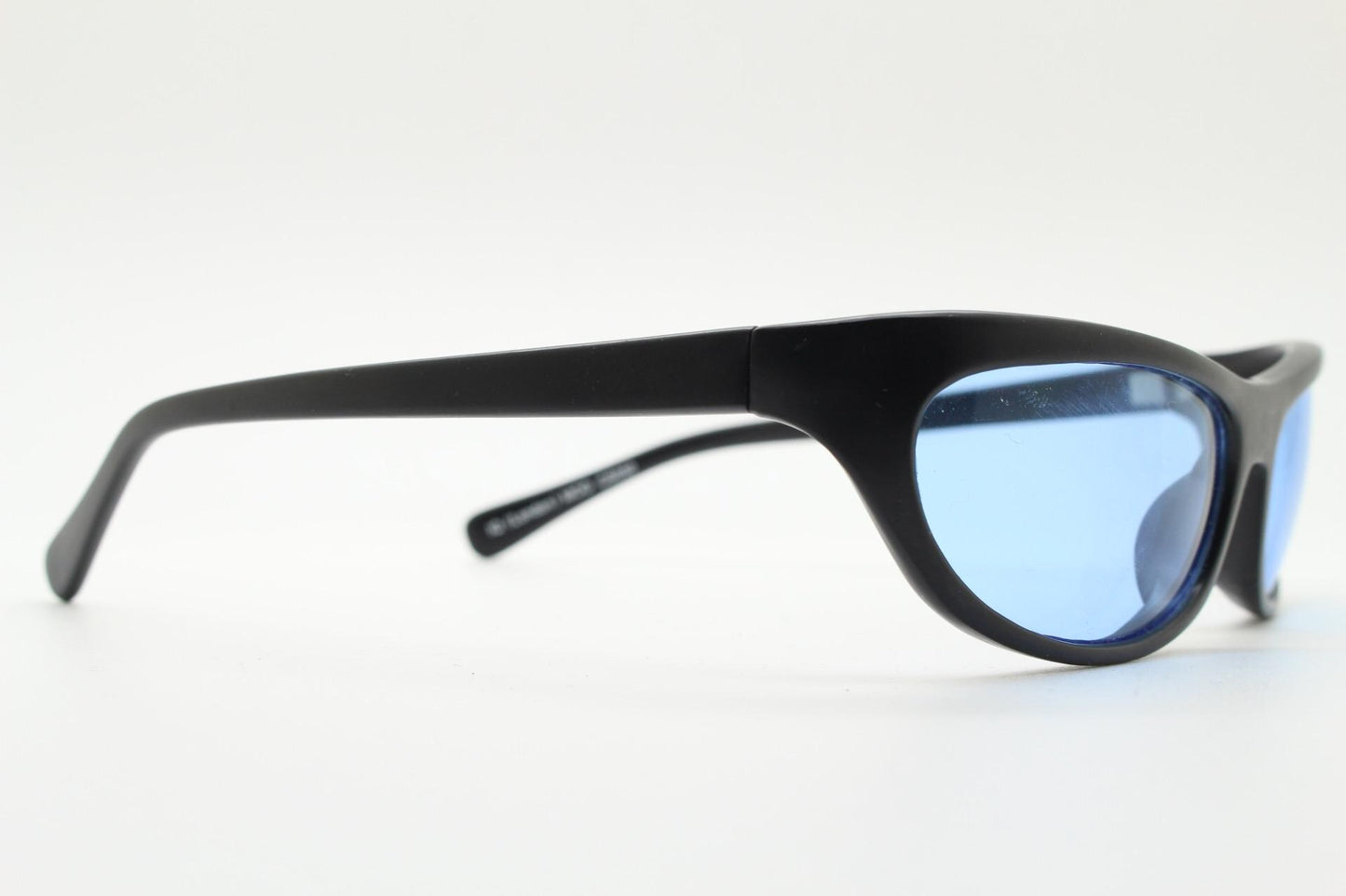 90s vintage curved wraparound sunglasses. Aerodynamic low profile black satin finish frame with light tone blue lenses. Sports shield. NOS